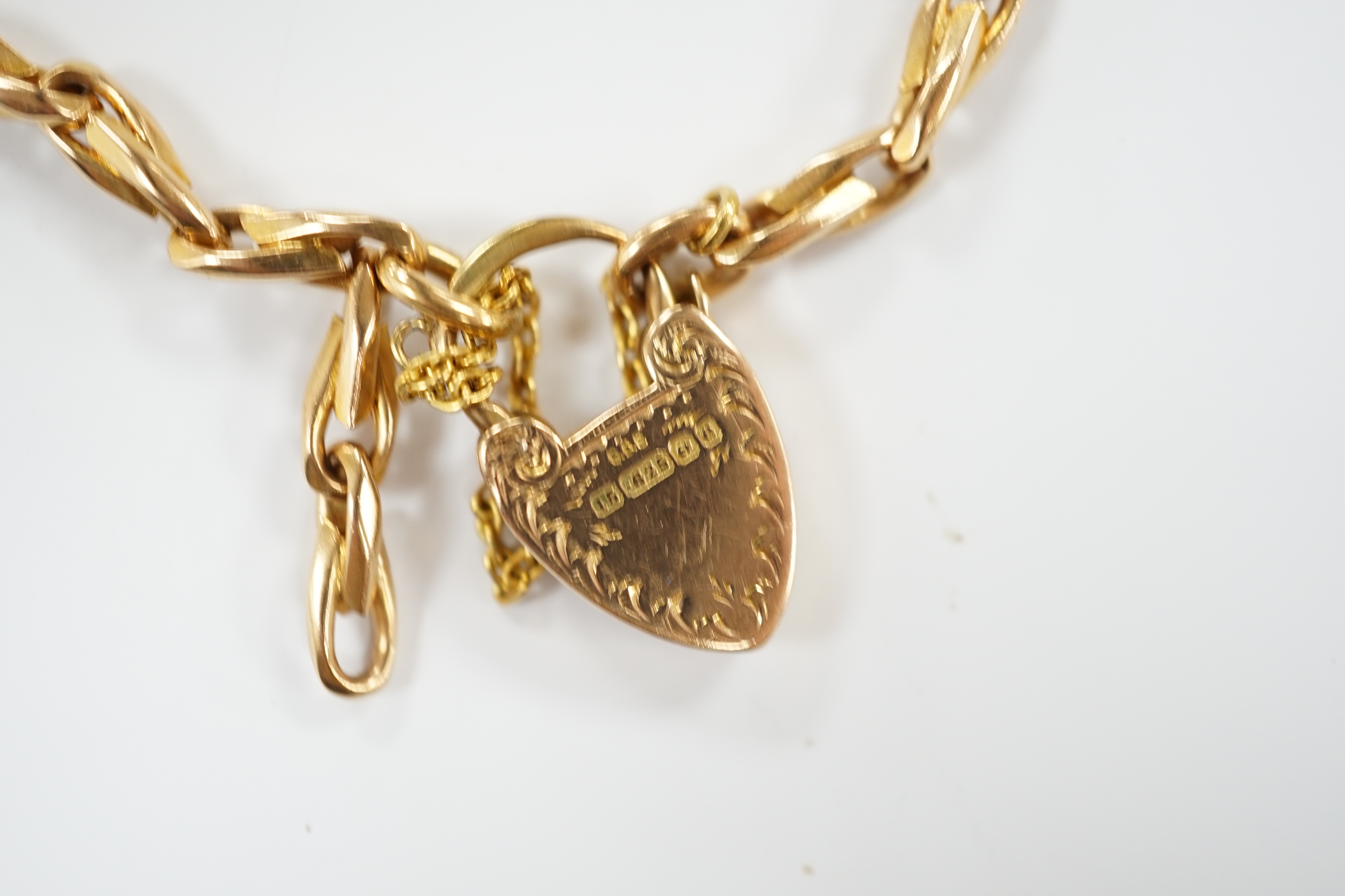 An Edwardian 15ct gold oval link bracelet with heart shape padlock clasp, 18cm, 24.6 grams.